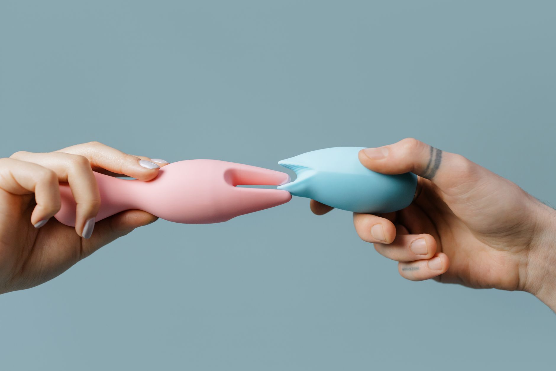 Hand holding a fresh lemon on soft pink background, representing gentle reconnection and renewal
