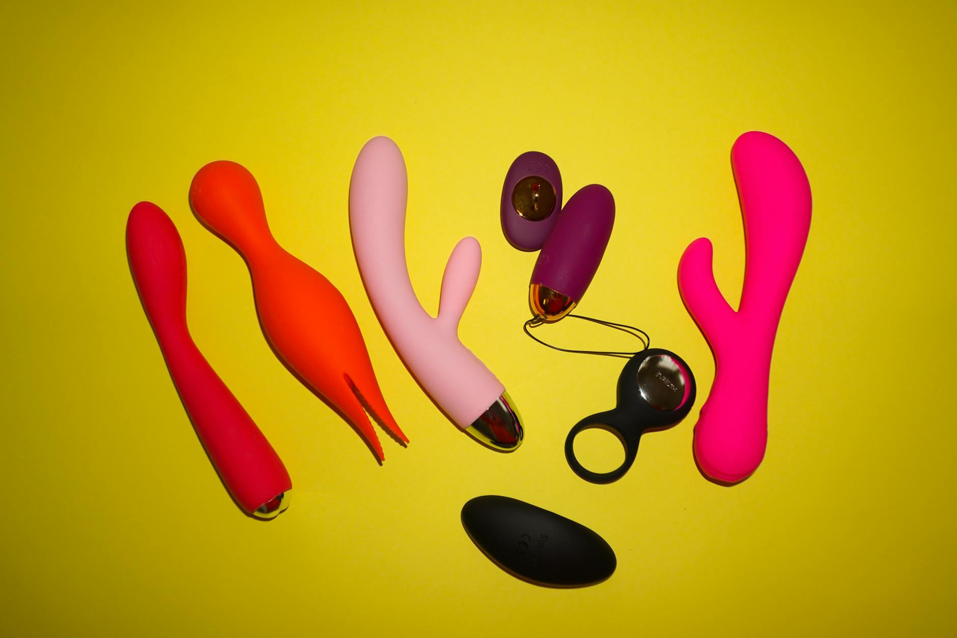 Woman holding clitoral vibrators, exploring pleasure and sexual wellness